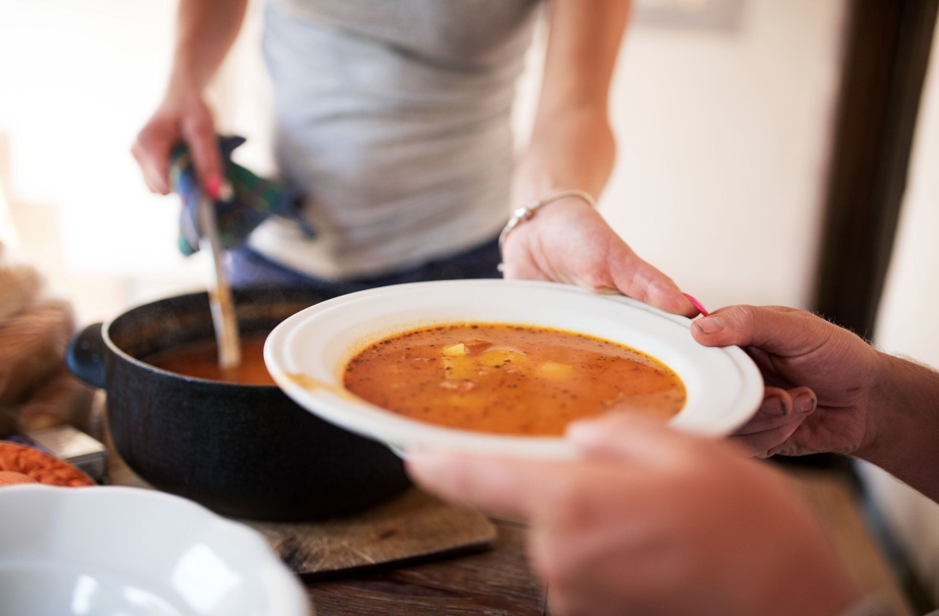 woman-serving-plate-soup-men-1484831690-2880w